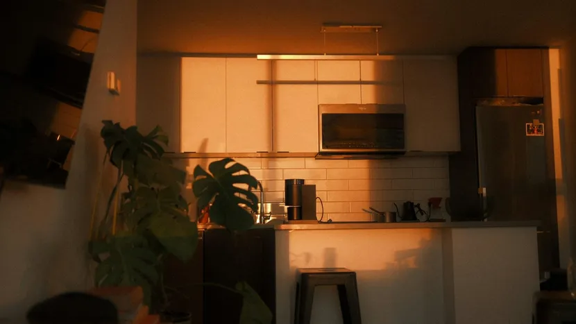 A home kitchen lit by warm evening light, with nothing cooking.